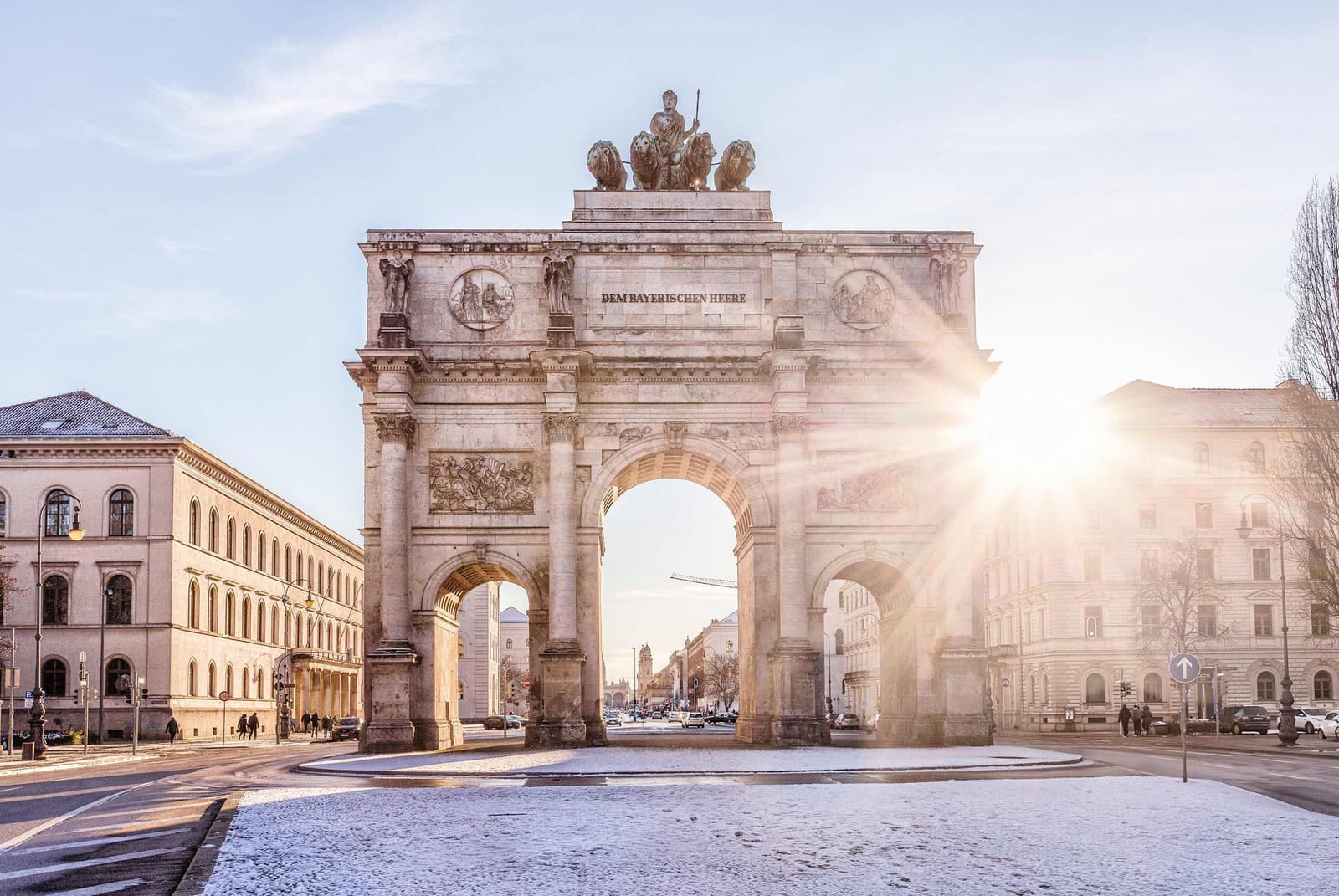 The sun rising behind the Siegestor in Munich, Germany