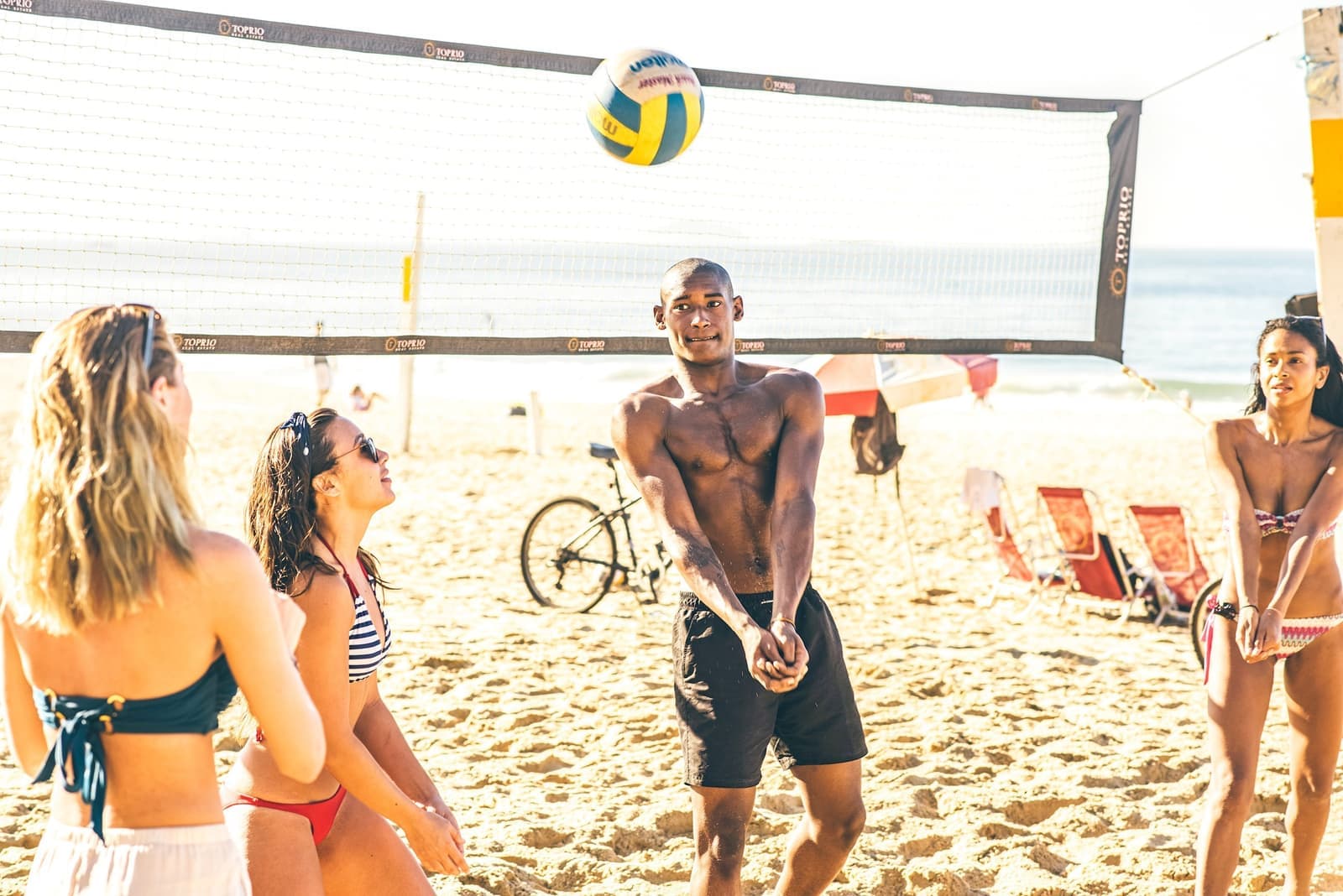 Travellers playing volleyball on the beach in Rio de Janeiro, Brazil