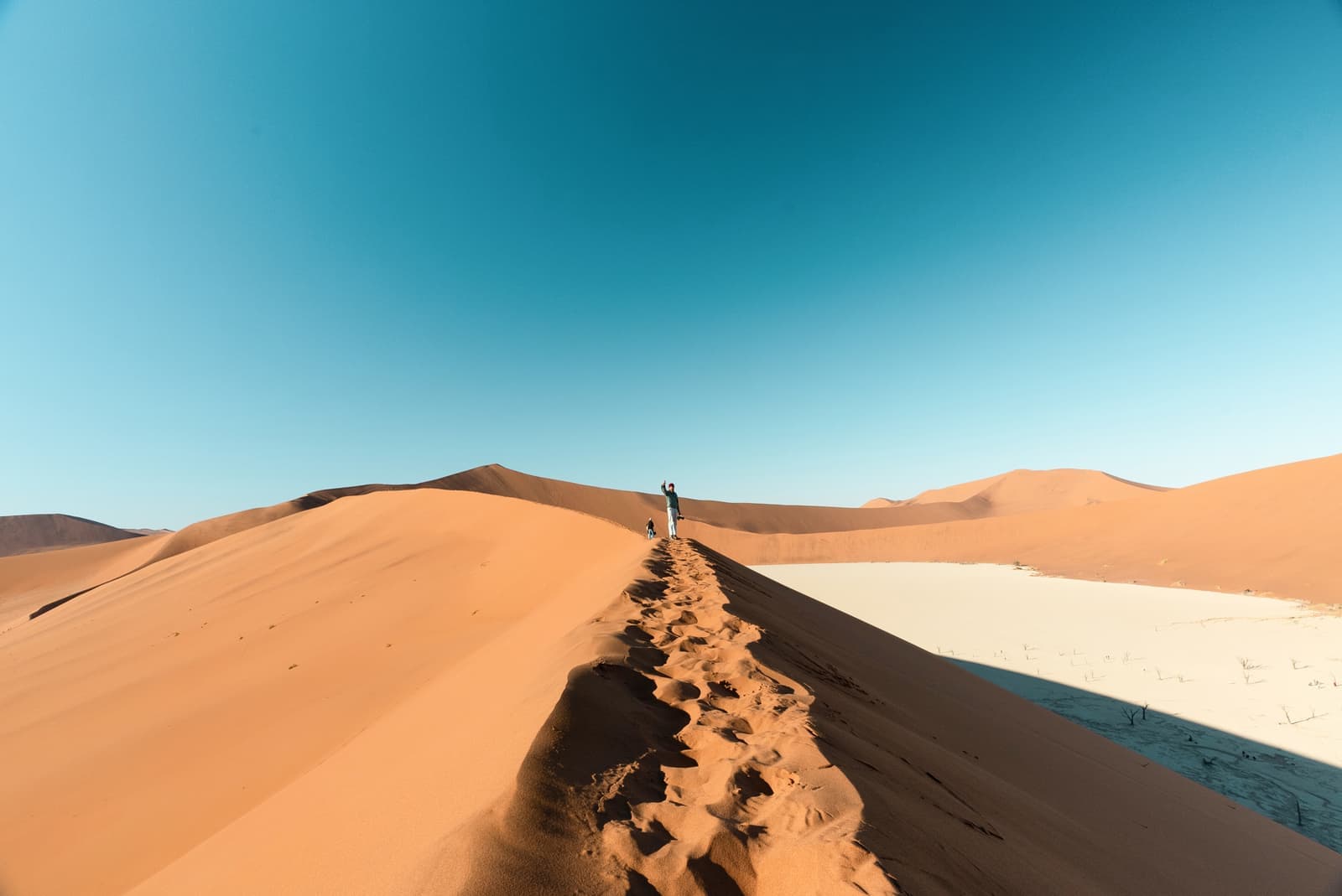 Traveller stood at the Big Daddy sand dune in Sossusvlei, Namibia