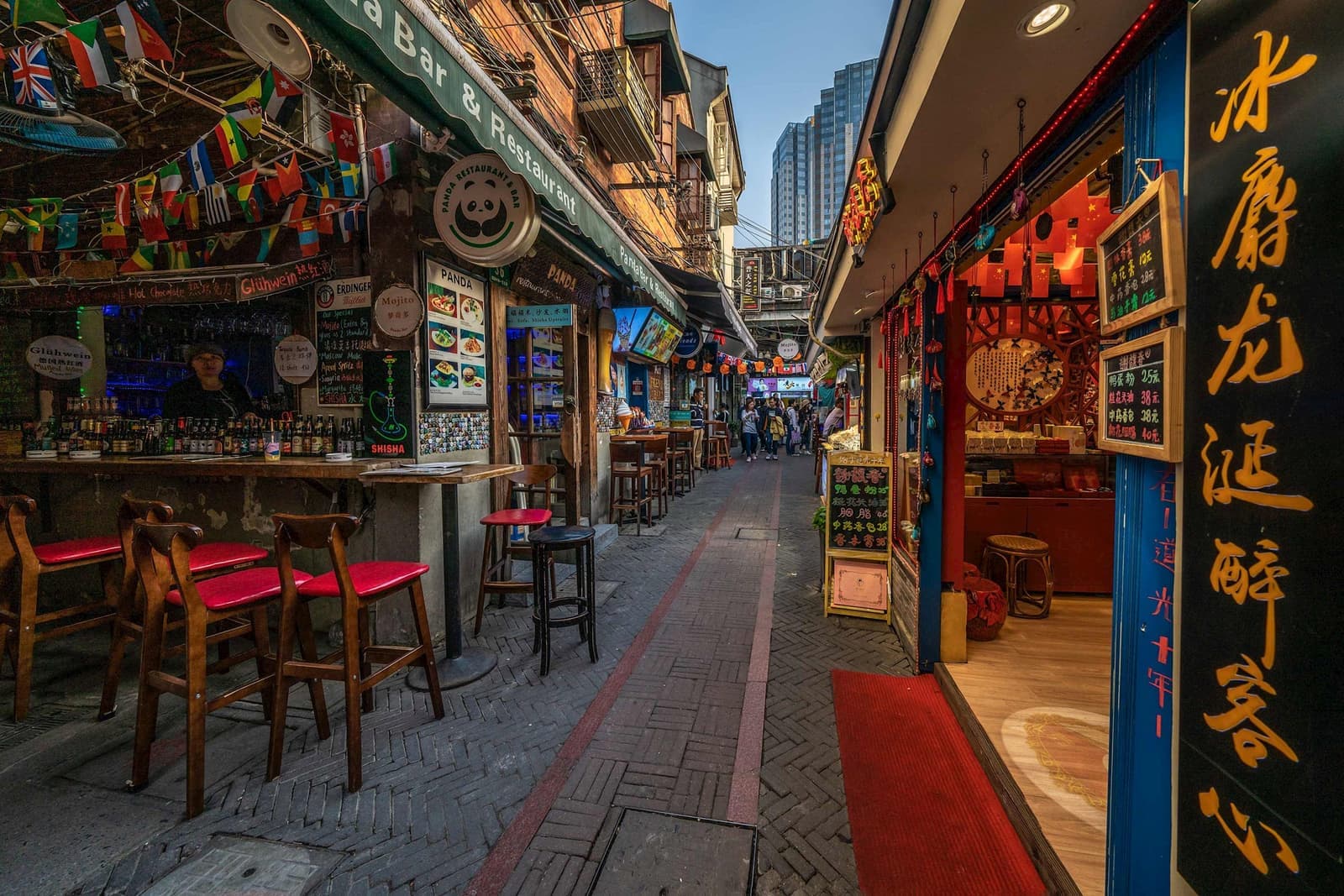 Evening view of street shops and bars in Shanghai, China