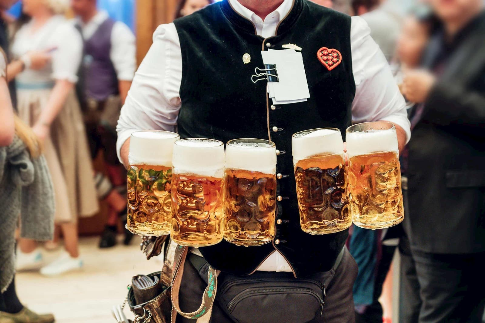 A person holding five jugs of beer in Munich, Germany