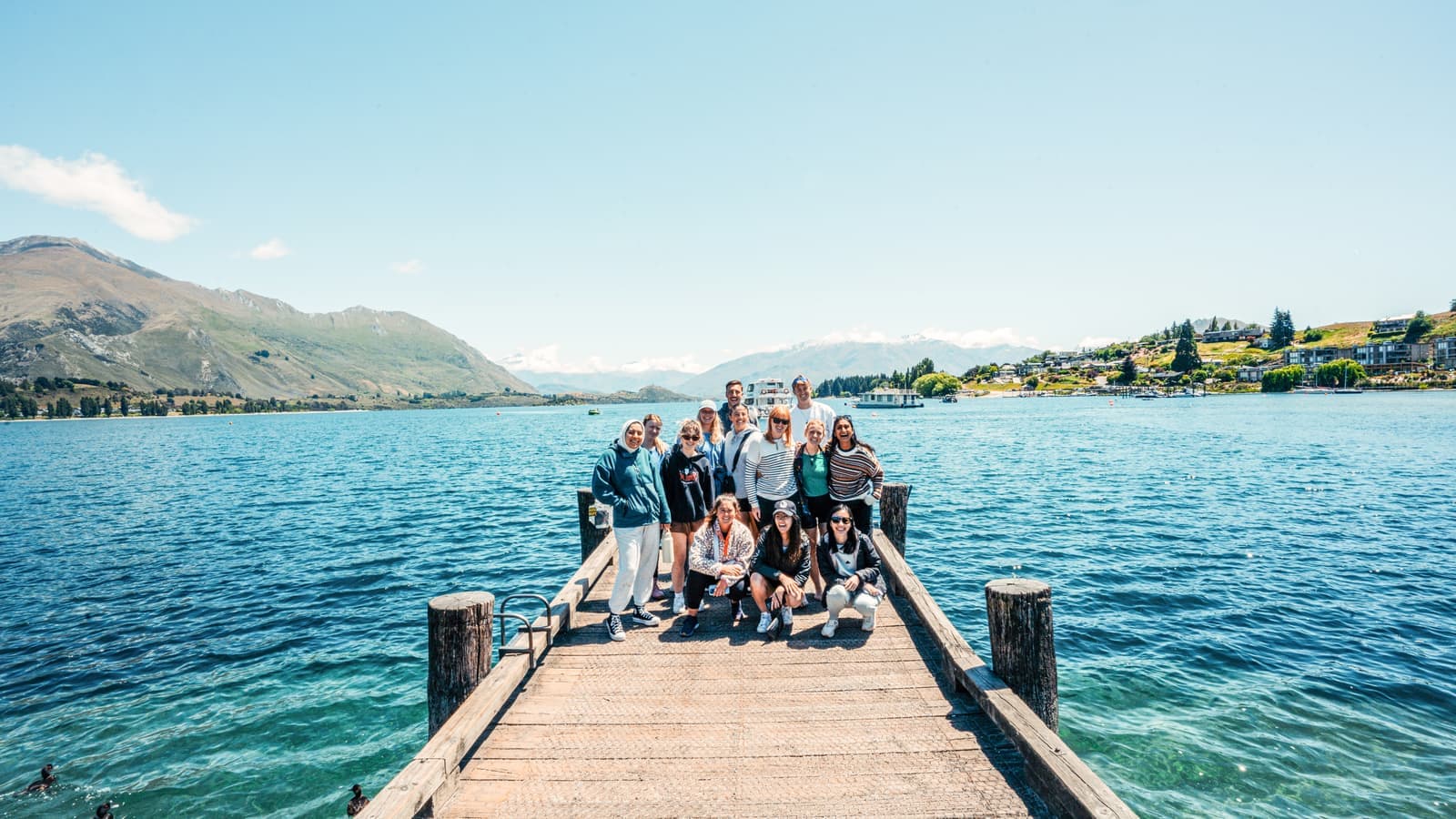 Group of traveller standing on a dock over a lake, Queenstown, New Zealand