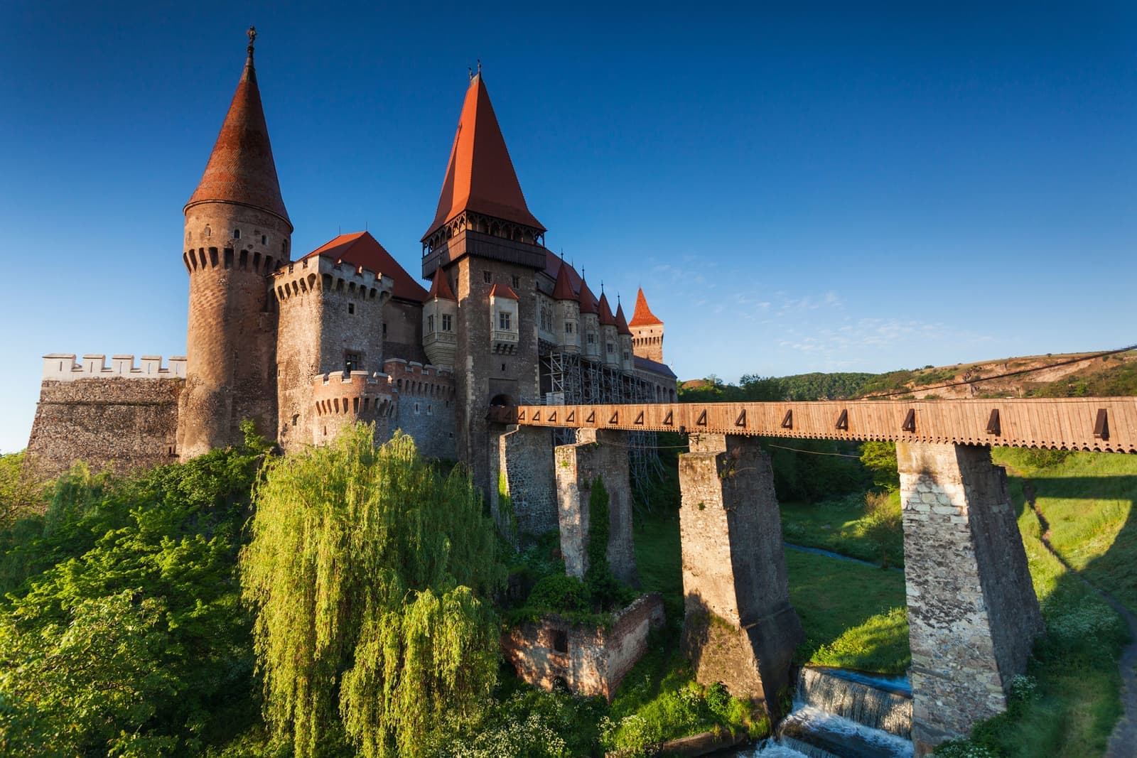 Corvin Castle in Hunedoara and stone bridge over moat in Hunedoara, Romania