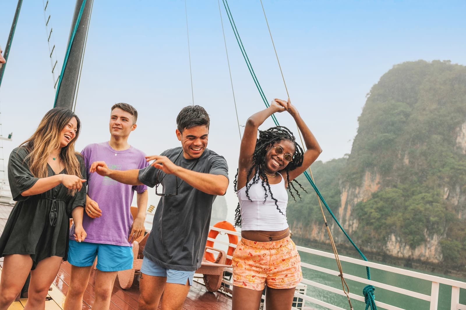 Travellers dancing onboard a boat in Halong Bay in Vietnam
