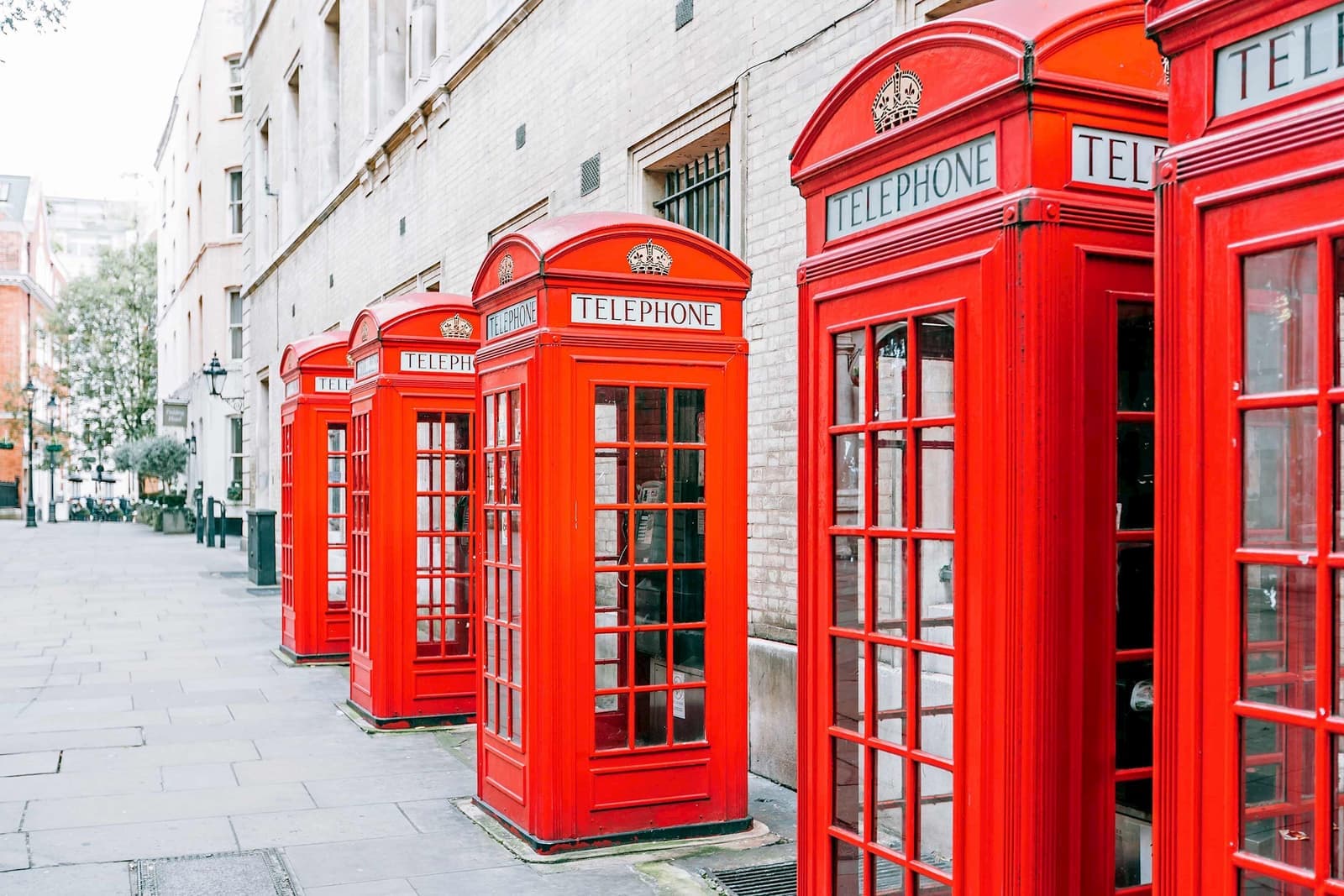 A line of red telephone booths in London, England