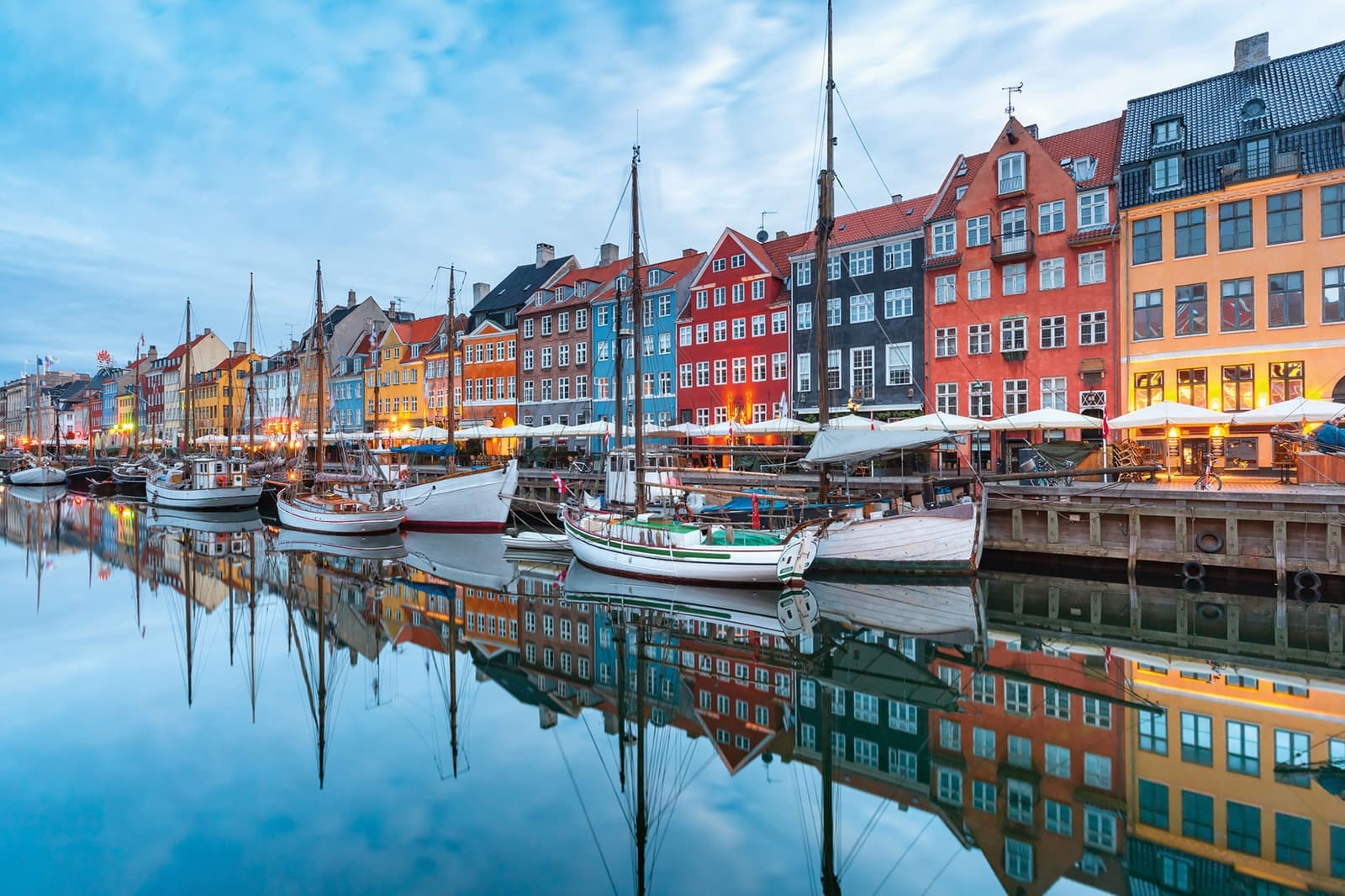 See the colourful houses in Nyhavn, Copenhagen, Denmark