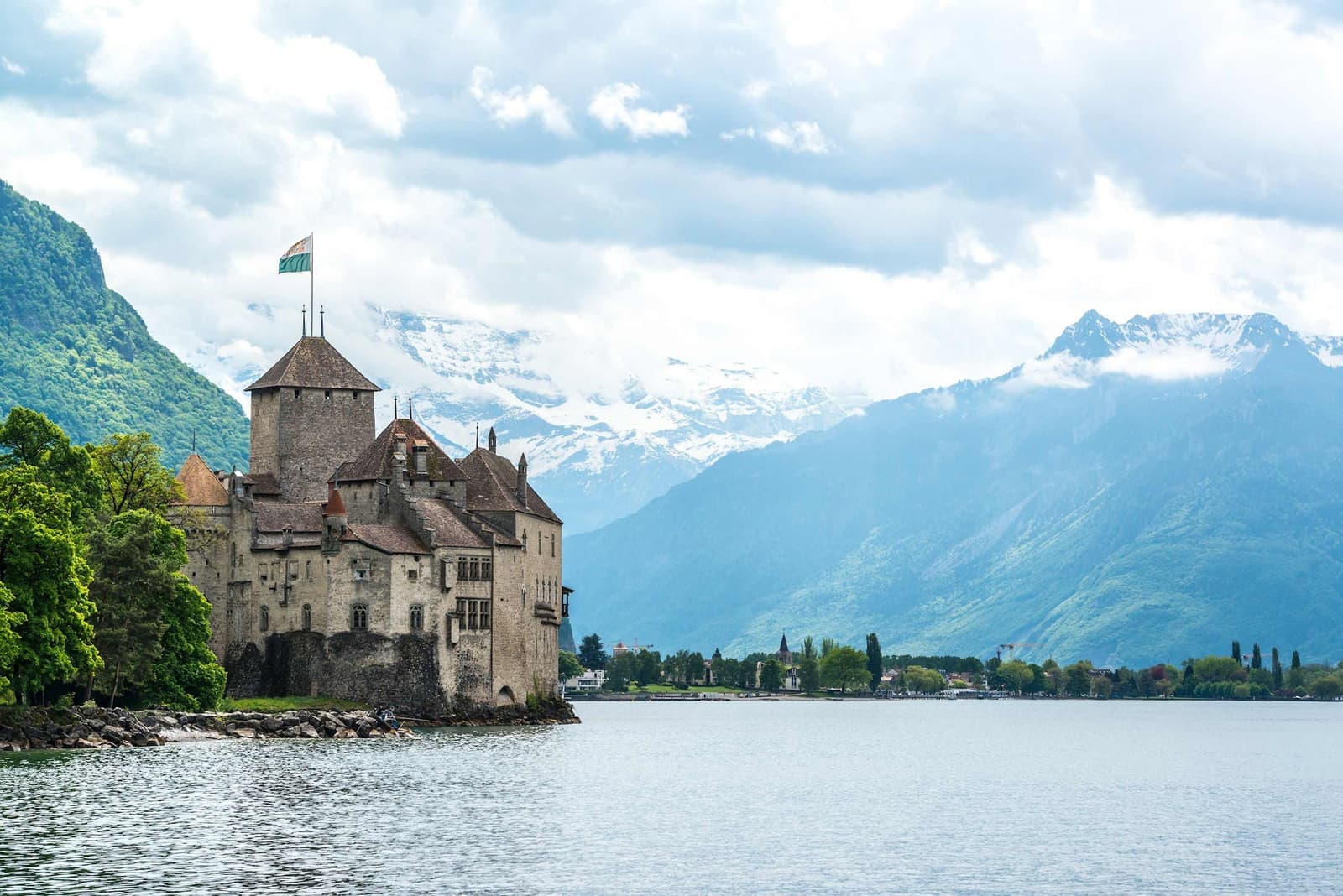 Chillon Castle by Lake Geneva with Alps in the background