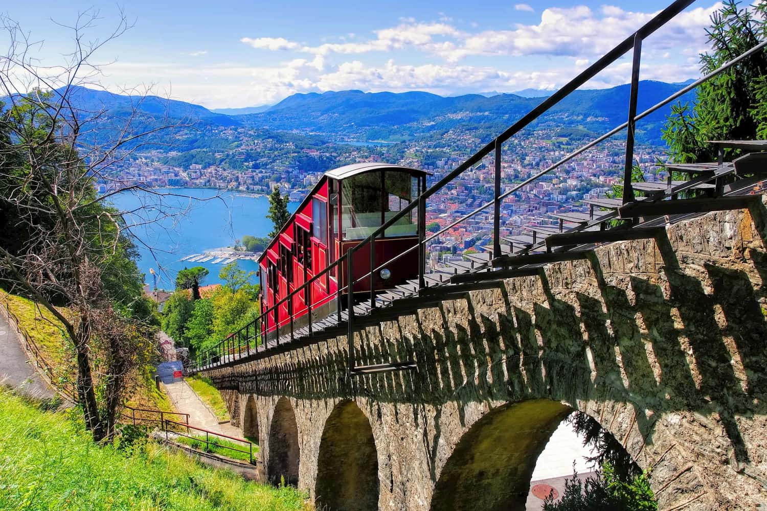 Enjoy a scenic lake cruise of Lake Lugano then board the funicular to the summit of Lugano’s of the mountain