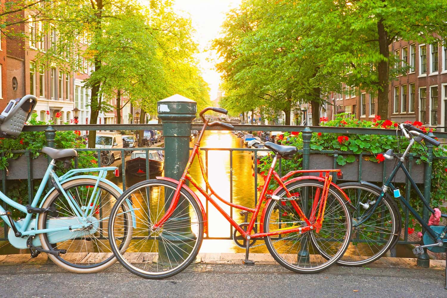 Row of colourful bicycles on a bridge above canal in Amsterdam, Netherlands