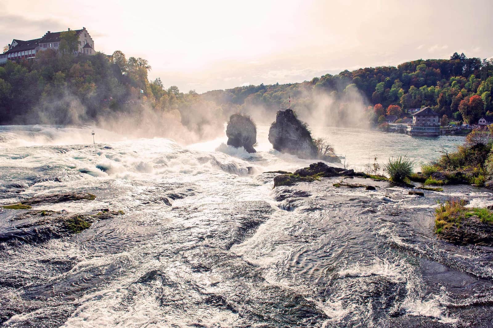 Rhine Falls in Schaffhausen with cascading water and mist over rocky outcrops
