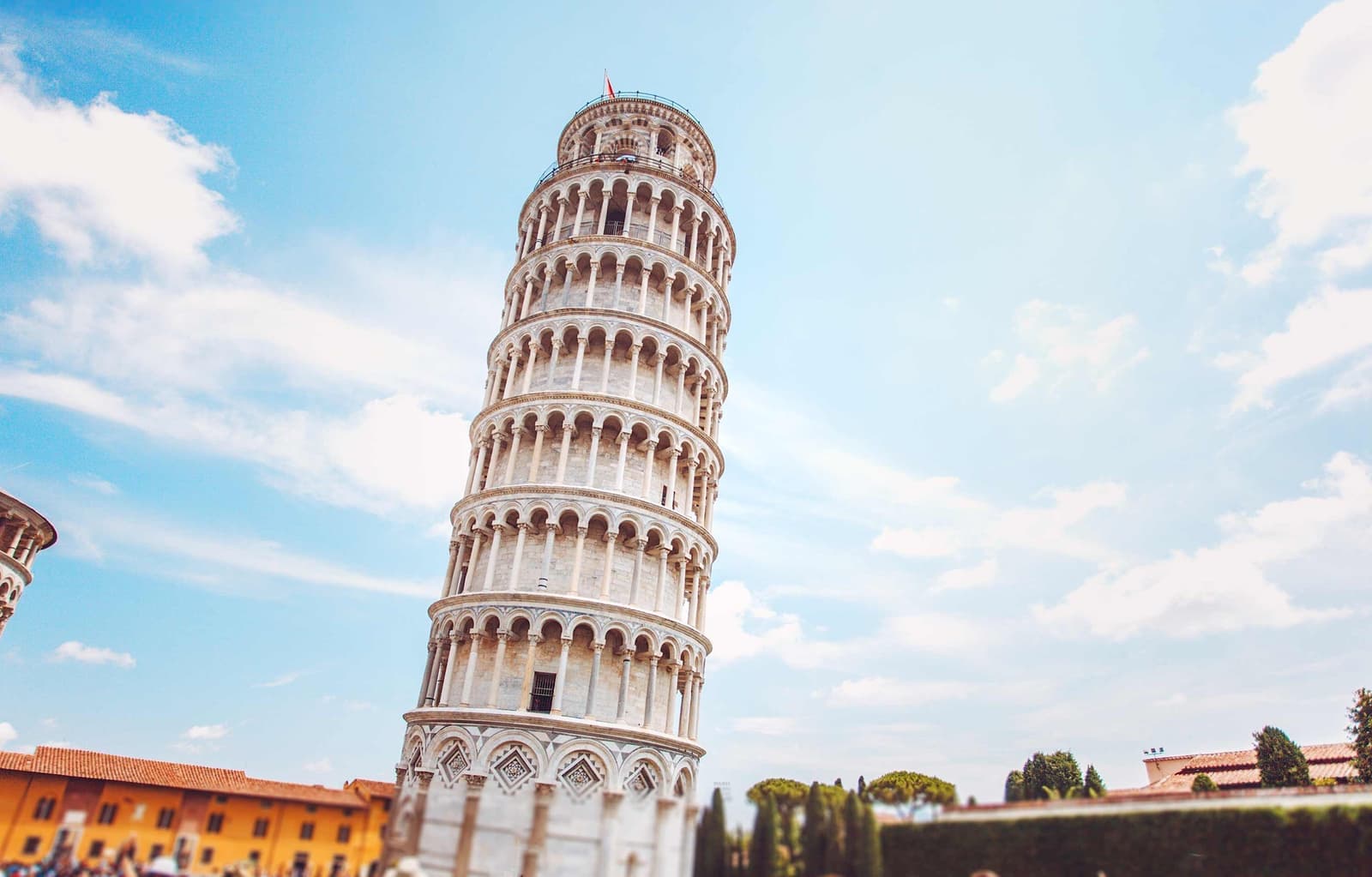 Leaning Tower of Pisa with surrounding buildings and trees