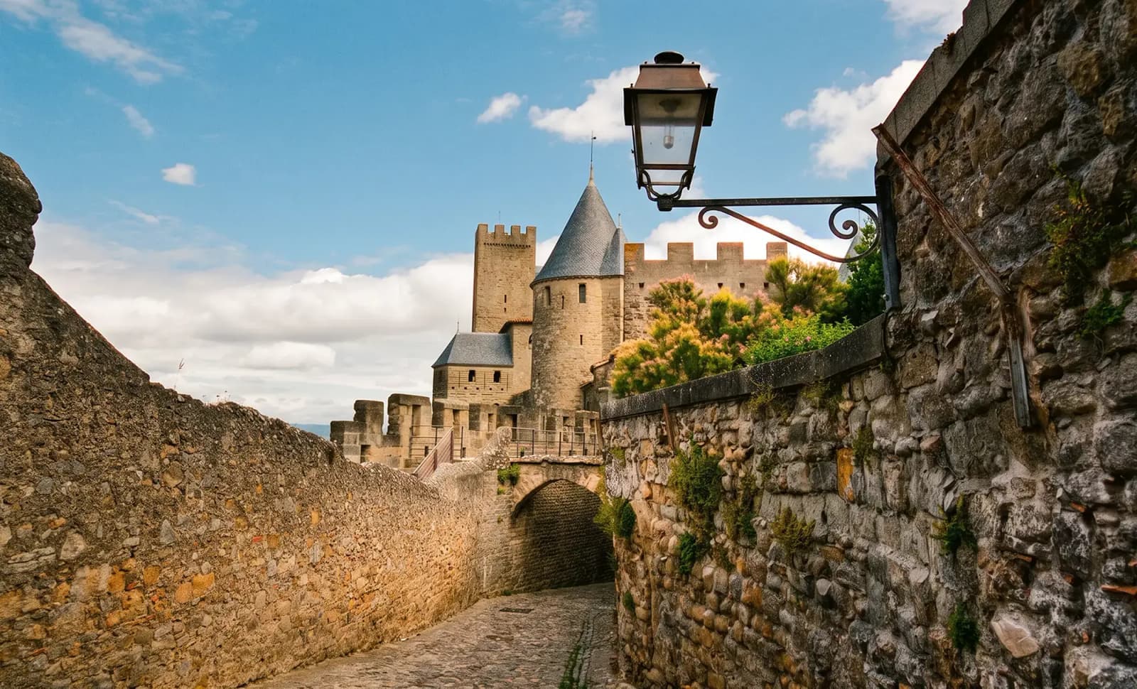A stone path leading to the medieval castle towers of the Cité de Carcassonne, France.