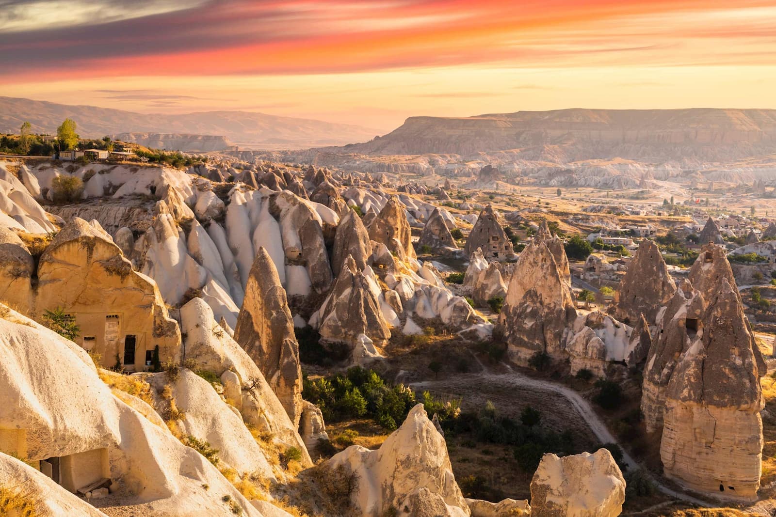 Sunset view over rocky fairy chimneys and valleys of Goreme park, Cappadocia, Turkey.