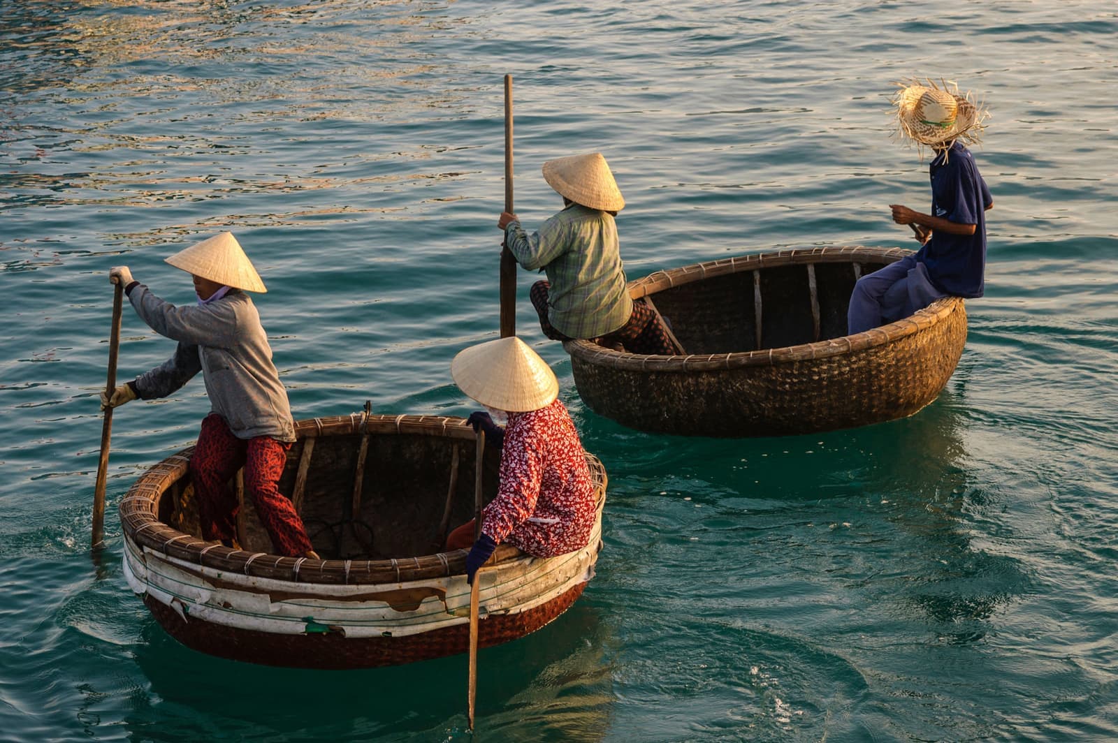 Vietnamese Round Boats with people rowing, Hoi An, Vietnamb