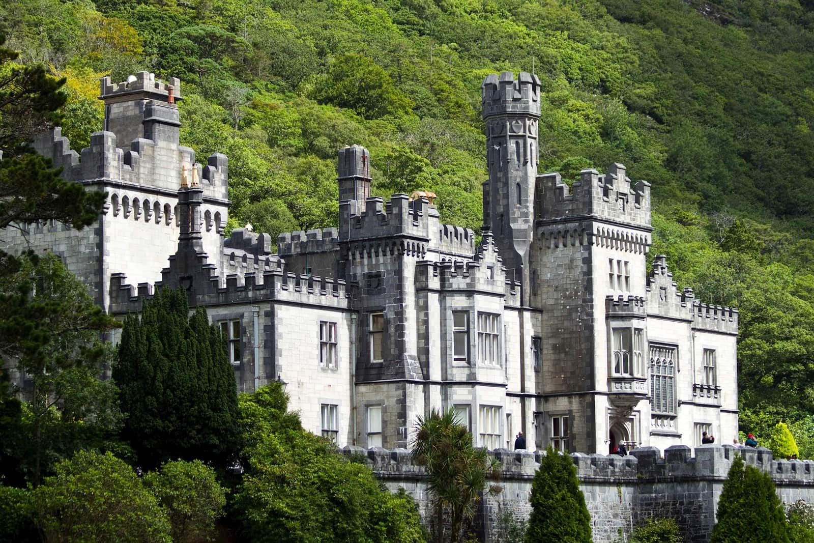 Kylemore Abbey’s neo-Gothic castle facade set against green hill