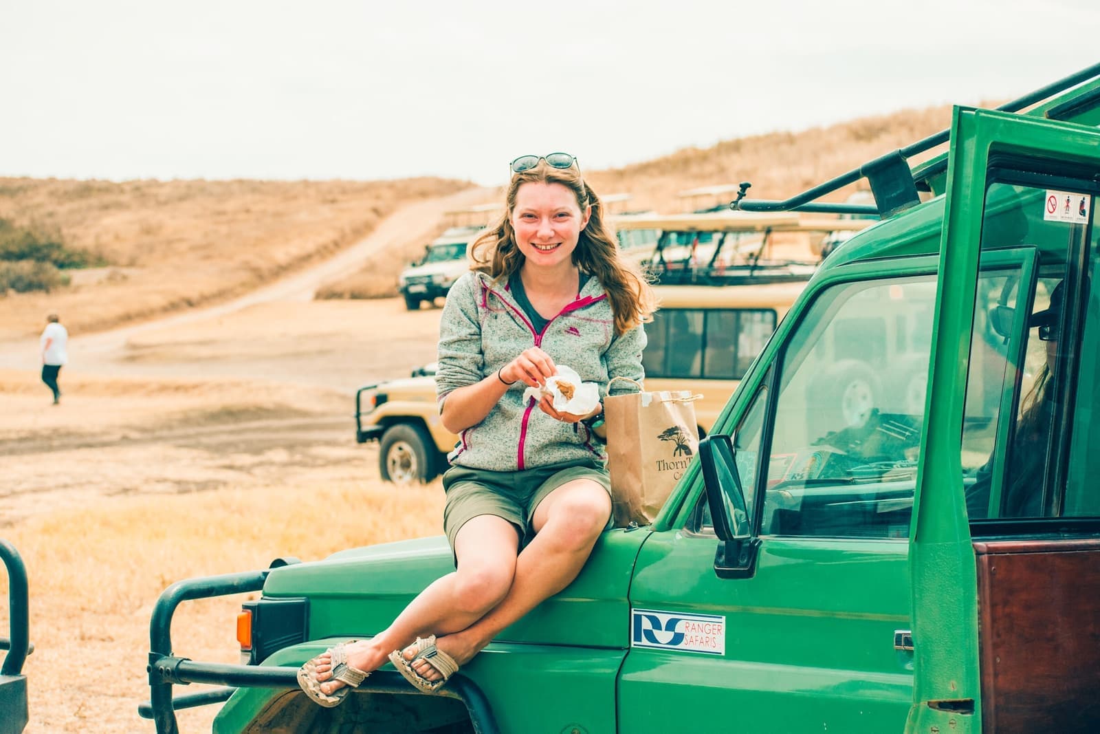 Traveller sat on a jeep at the Ngorogoro Crater in Tanzania