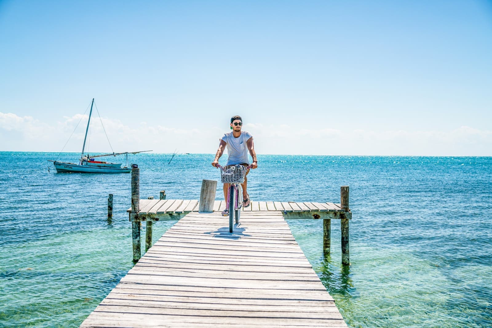 Traveller on a bike on a boardwalk in Caye Caulker, Belize