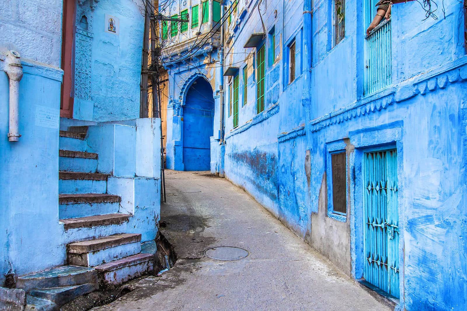 Vibrant blue-washed houses line a narrow alleyway in Jodhpur, India