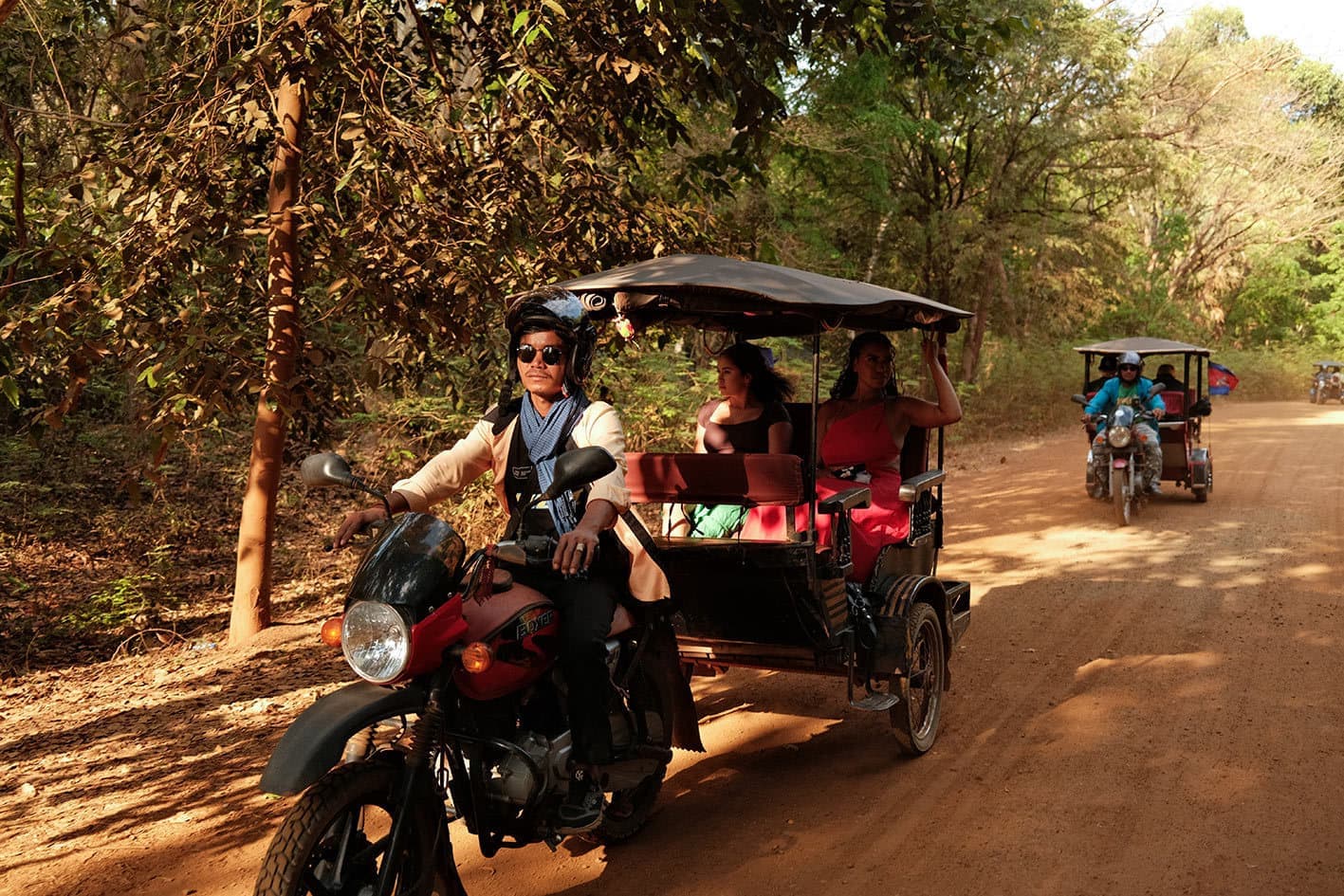 Tuk Tuk Driver Transporting Travellers Along a Quiet Road, Cambodia
