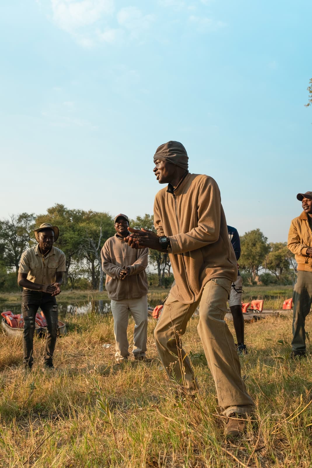 Local guides standing in a field, Maun, Botswana