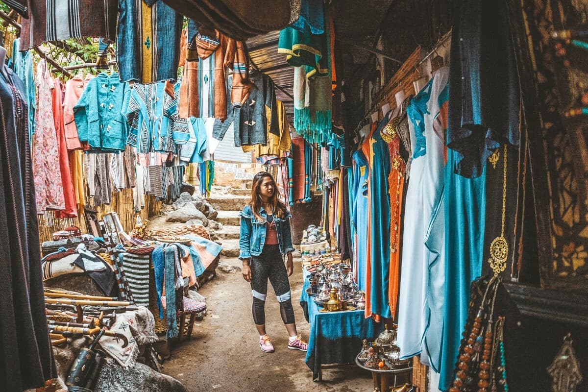 Traveller at a local clothing market in Marrakech, Morocco