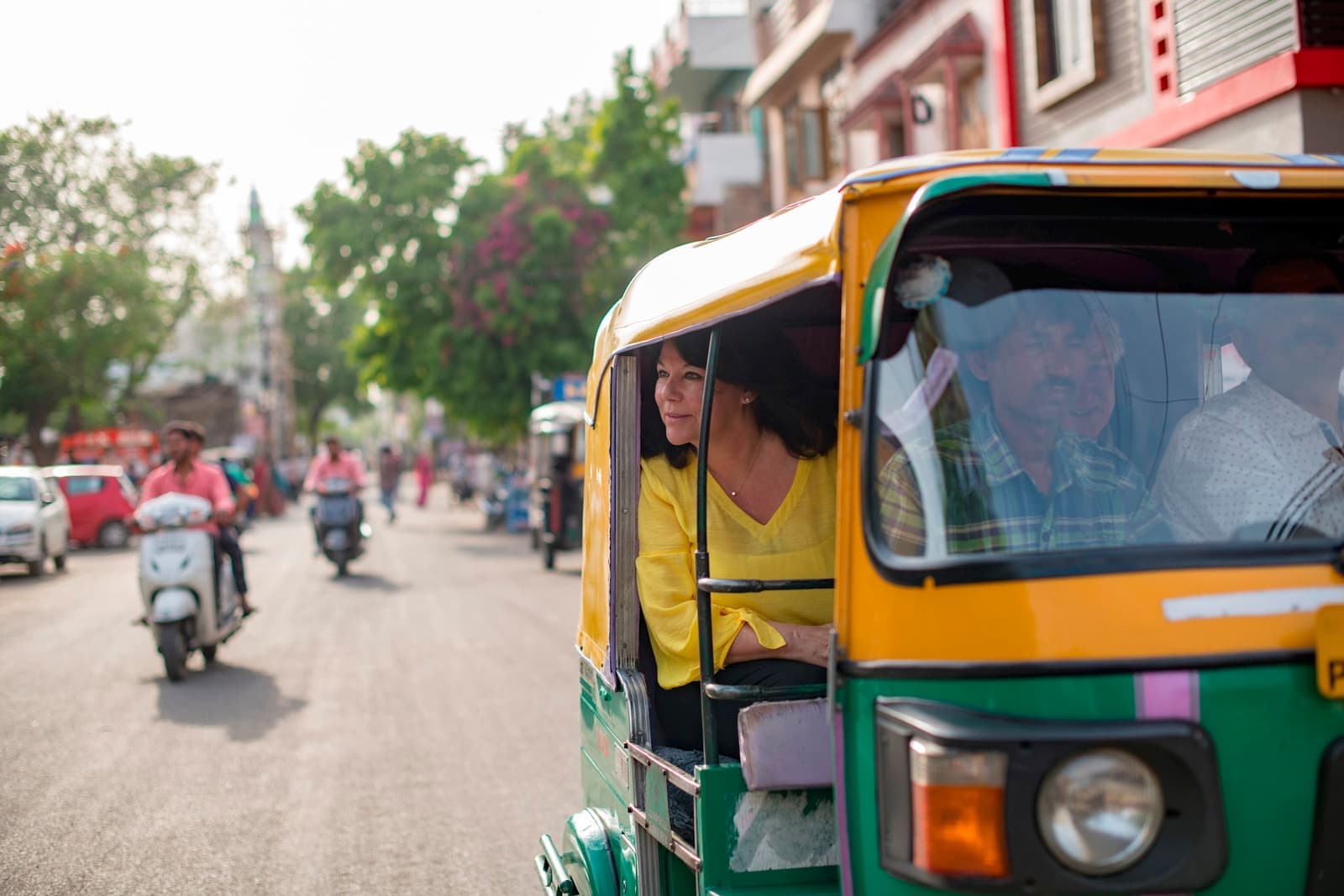 People riding a tuk-tuk during a tour in Colombo, Sri Lanka