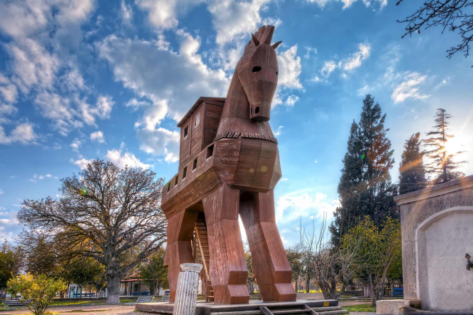 Large wooden Trojan Horse replica displayed outdoors under a bright sky, Turkey
