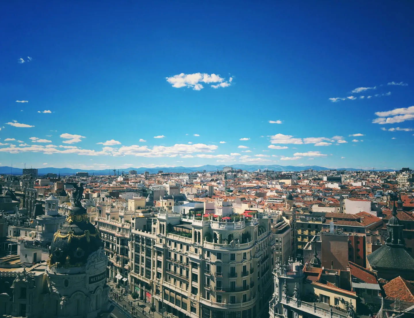 A breathtaking aerial view of Madrid's vibrant cityscape under a clear blue sky.
